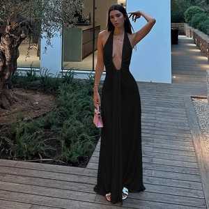 Detail of elegant black deep V-neck halter dress with open back and flowing maxi skirt