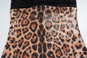 Detailed view of leopard print fabric with black lace and shimmering sequins embroidery