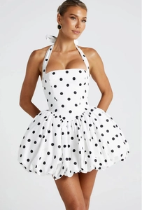 Detail of white polka dot halter dress featuring a structured bodice and bubble skirt hem
