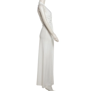 Side view of white halter neck knit dress featuring elegant ruched waist and floor length hem