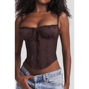 Detailed view of dark brown lace-up corset top with delicate lace stitching and bows