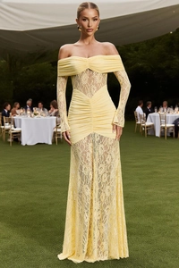 Close-up of pale yellow off-shoulder lace evening gown with floral texture and ruffles