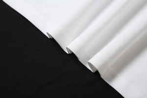 Macro detail of white knitted fabric showing precise double-needle stitching and texture