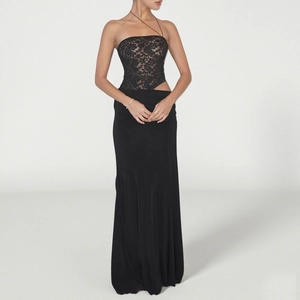 Close-up of intricate black lace floral embroidery and shimmering fabric on dress