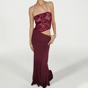 Detail of burgundy lace bandeau top with asymmetrical hem and matching slim-fit skirt