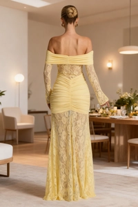 Detail of elegant yellow lace dress showing off-shoulder pleated neckline and long sleeves