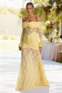 Close-up of delicate yellow lace fabric and elegant off-the-shoulder pleated neckline
