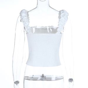Detail of white smocked tank top featuring ruffled straps and elastic texture