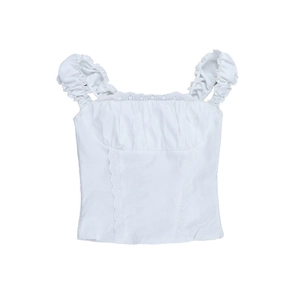 Detail of white sleeveless top with ruffle straps and vertical lace embroidery inserts
