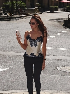 Elegant beige satin tank top with intricate black lace embroidery and slim fit design