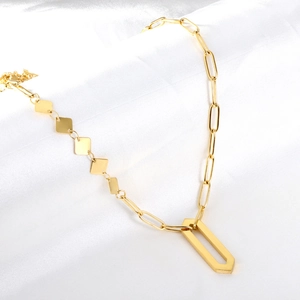 Detail of 18K gold-plated necklace featuring a geometric hex pendant and diamond-shaped accents