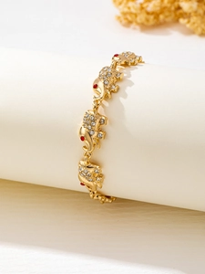 Detailed close-up of gold elephant charm bracelet featuring sparkling white crystal inlay