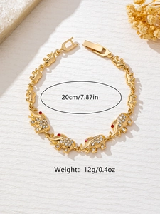 Detailed view of vintage gold elephant charm bracelet with crystal accents and chain links
