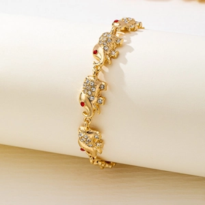 Golden elephant link bracelet with sparkling white crystals and red gem eyes for women