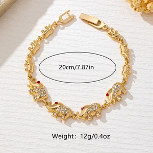 Golden elephant link bracelet with sparkling rhinestones and red eye accents, 20cm length