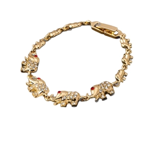 Vintage golden elephant bracelet featuring sparkling white rhinestones and red gem eyes