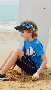 Close-up of kids sun visor with cartoon print on a beach background with high breathability