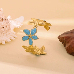 Golden stainless steel flower cuff bracelet with blue and yellow enamel floral details