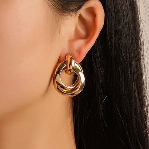 Minimalist interlocking gold hoop earrings with polished metal finish for women