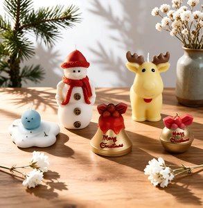 Creative Christmas candle set featuring snowman, reindeer, and bell shapes on wood