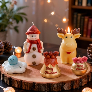 Festive Christmas candle set with snowman, elk, and bell shapes on a rustic wooden base