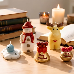 Christmas candle set with snowman, elk and bell shapes on a cozy wooden table background