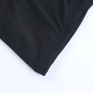Detail of the double-needle stitching on the black strapless dress hem and fabric texture