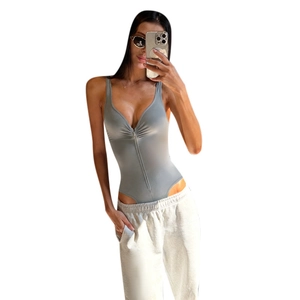 Detailed close-up of grey slim fit bodysuit featuring V-neckline and zip front detail