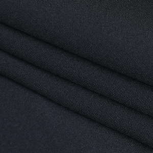 Macro shot showing the fine texture and soft draped layers of premium black knitted fabric