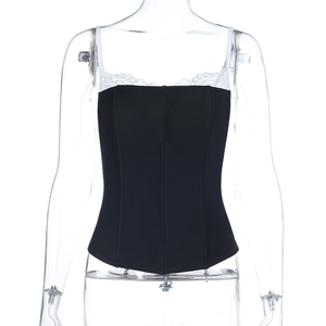 Detail of black corset top with white lace trim and thin straps on a model