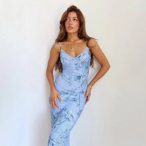 Detail of light blue A-line dress featuring vintage dark blue floral prints and slim straps