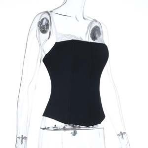 Close-up of black corset-style crop top with white lace trim and thin straps