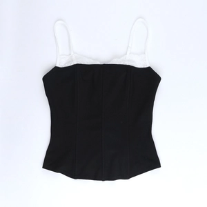 Detail of black crop top with white lace trim and adjustable thin spaghetti straps