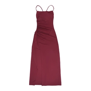 Close-up of side drawstring ruching and high slit on burgundy off-shoulder dress
