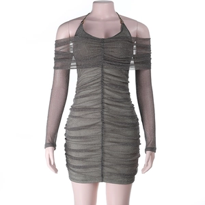 Detail view of the ruched glitter fabric and off-the-shoulder long sleeves of the dress