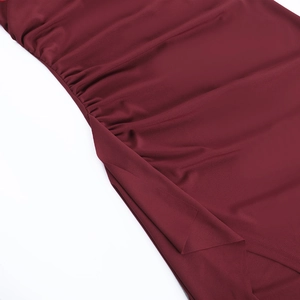 Detailed close-up of wine red fabric showing delicate ruching and fine stitching quality