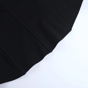 Close-up of black backless tank top showing vertical stitching and knitted fabric texture