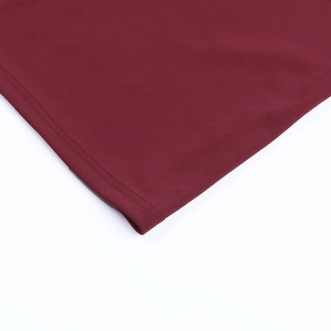 Close-up of the double-needle hem stitching on a deep red elegant evening dress