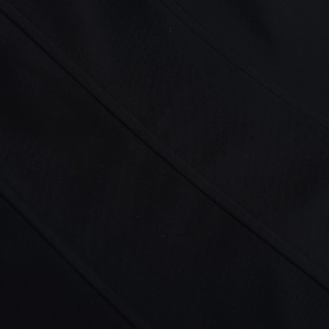 Close-up of black fabric texture featuring reinforced diagonal stitching for durability