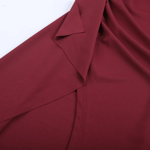 Macro detail of wine red chiffon fabric texture with clean inner stitching and draping