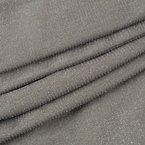 Detailed view of silver metallic Lurex fabric texture with sparkling shimmer for dresses