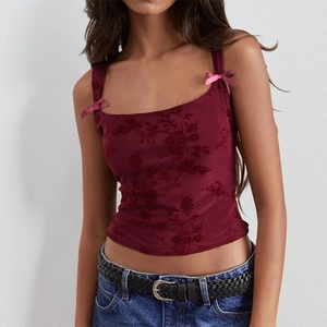 Detail of burgundy floral velvet camisole top featuring satin bow shoulder straps
