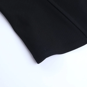 Detail shot of black knitted hem with professional double-needle stitching and texture