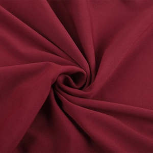 Macro shot of dark red chiffon fabric texture with soft drapes and matte finish