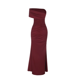 Macro shot of dark red evening dress featuring lace patchwork and glittering rhinestones