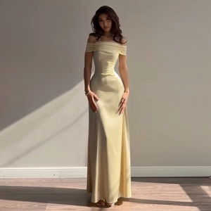 Detail of light yellow off-the-shoulder satin dress with elegant pleated neckline details