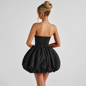 Detailed back view of a black corset dress showing the criss-cross lace-up design
