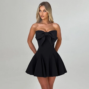 Detail of elegant black strapless mini dress featuring a large 3D bow design on the chest