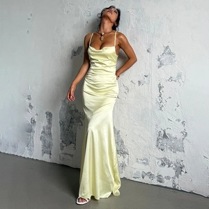 Detail view of smooth yellow satin fabric and elegant drapery on the A-line evening dress