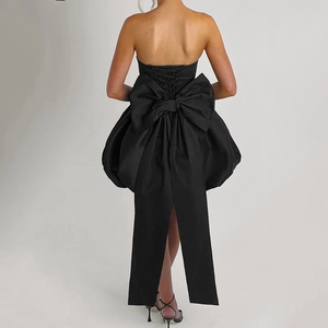 Detail of black strapless mini dress with large bow decoration and back lace-up closure